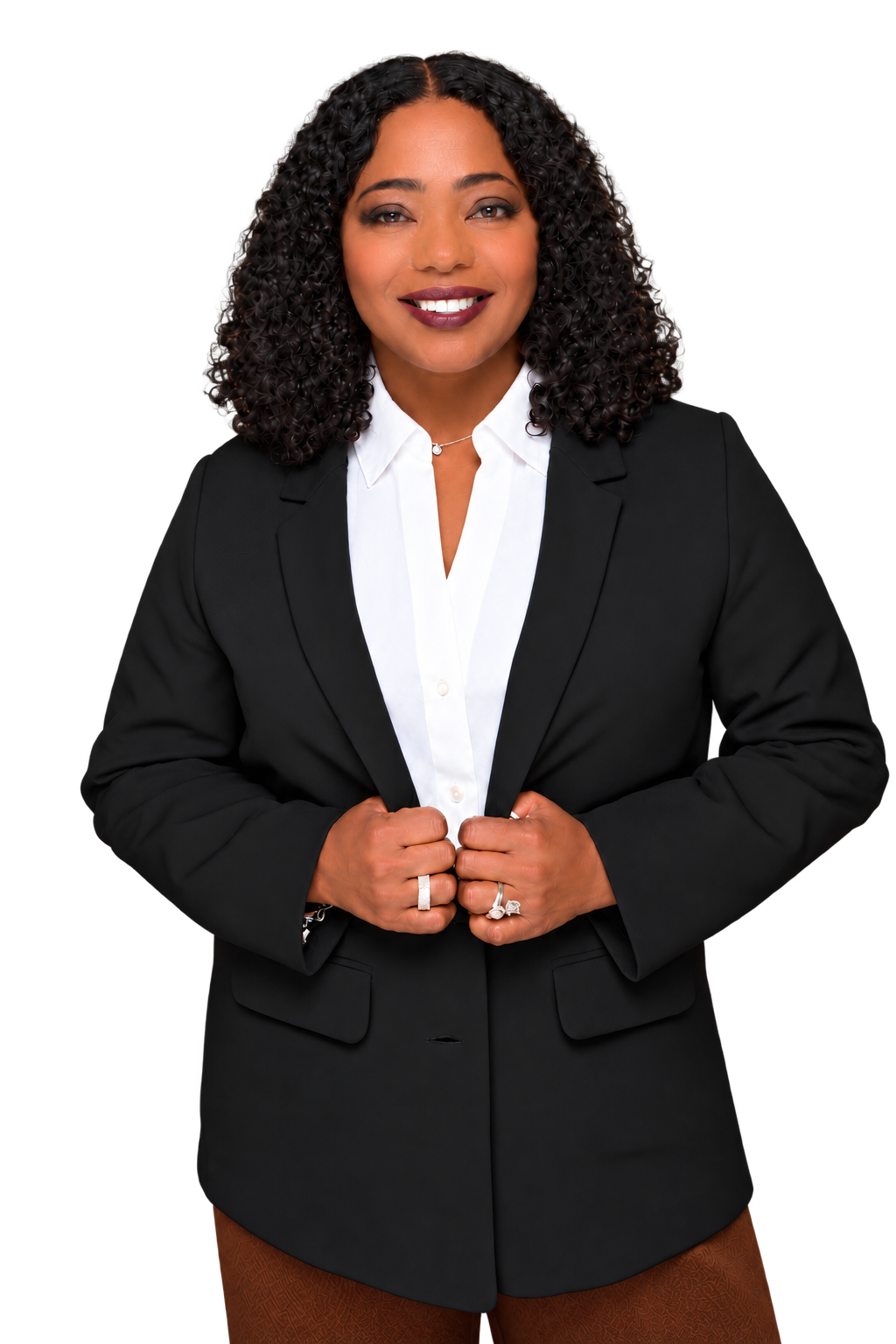 Cocoa Brown smiling in a black blazer and white shirt